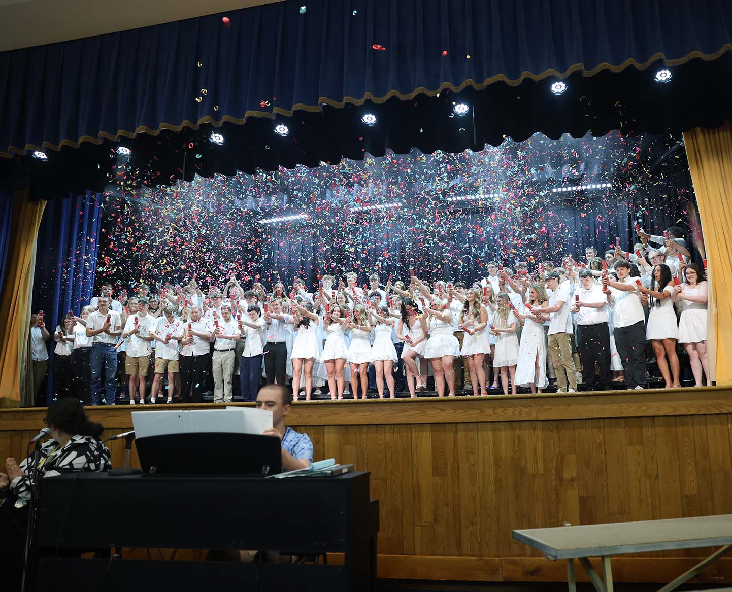 class of 2026 students on stage at moving up day with confetti poppers