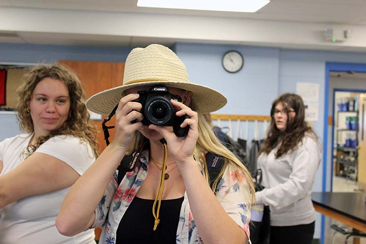 hs student taking a picture with a camera