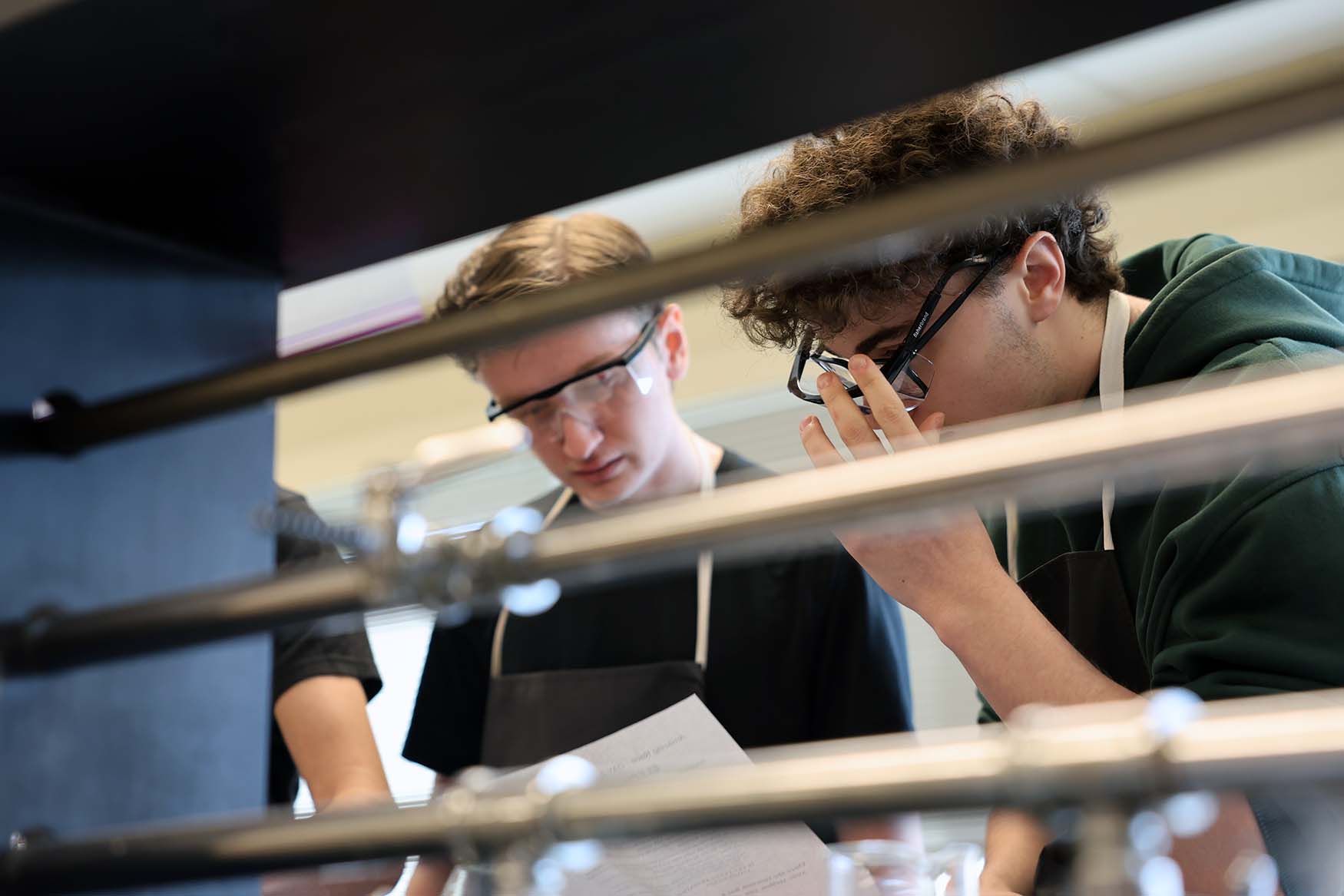 student in lab with safety glasses and aprons on