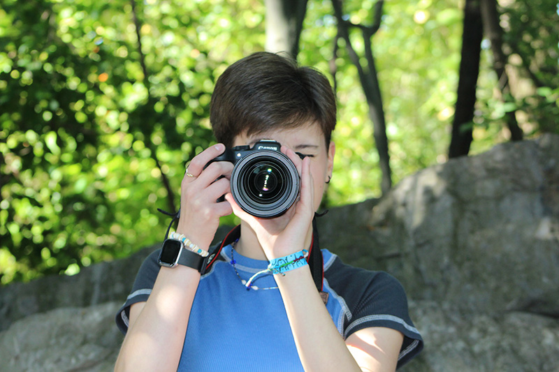 HS female taking picture with camera