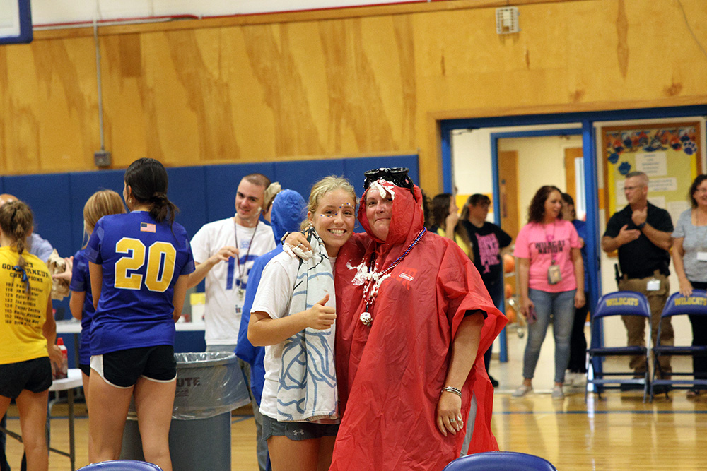 faculty with student after being pied in face