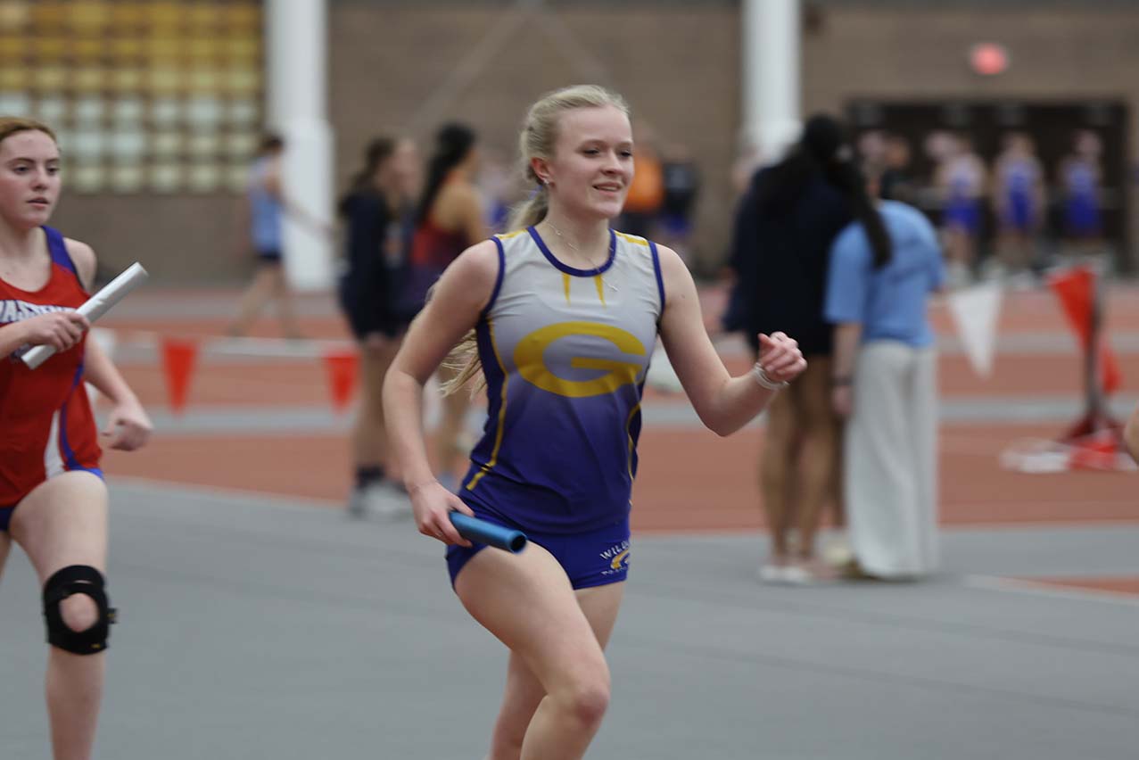 girl running on track at SLU meet