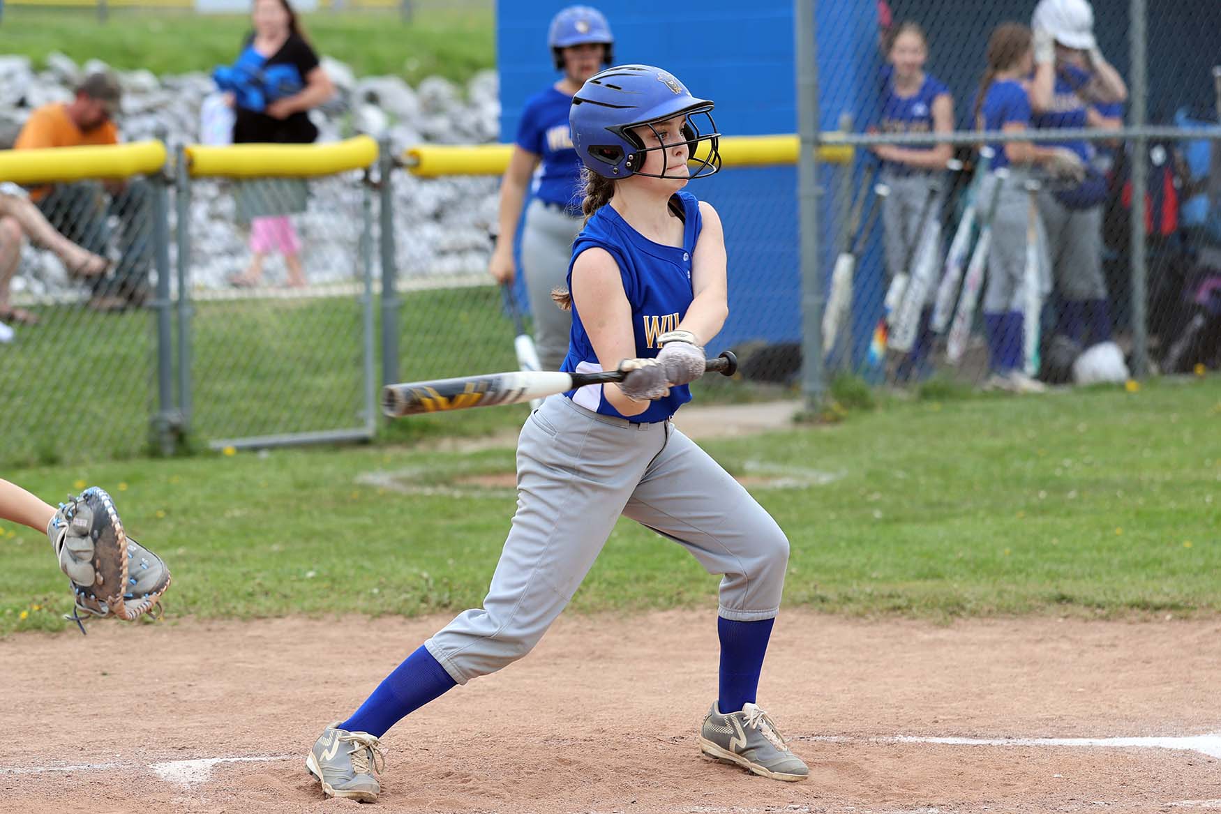 softball player about to strike ball with bat