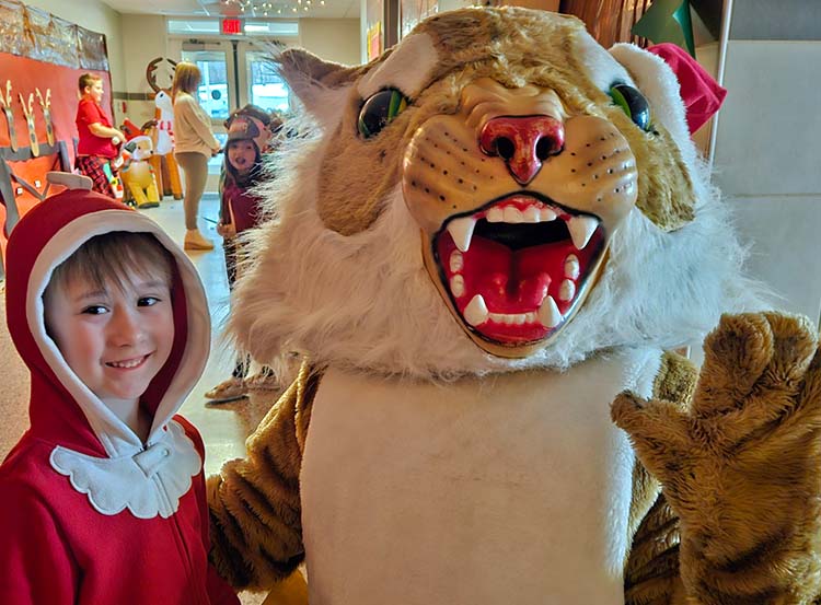 elementary student with wildcat mascot