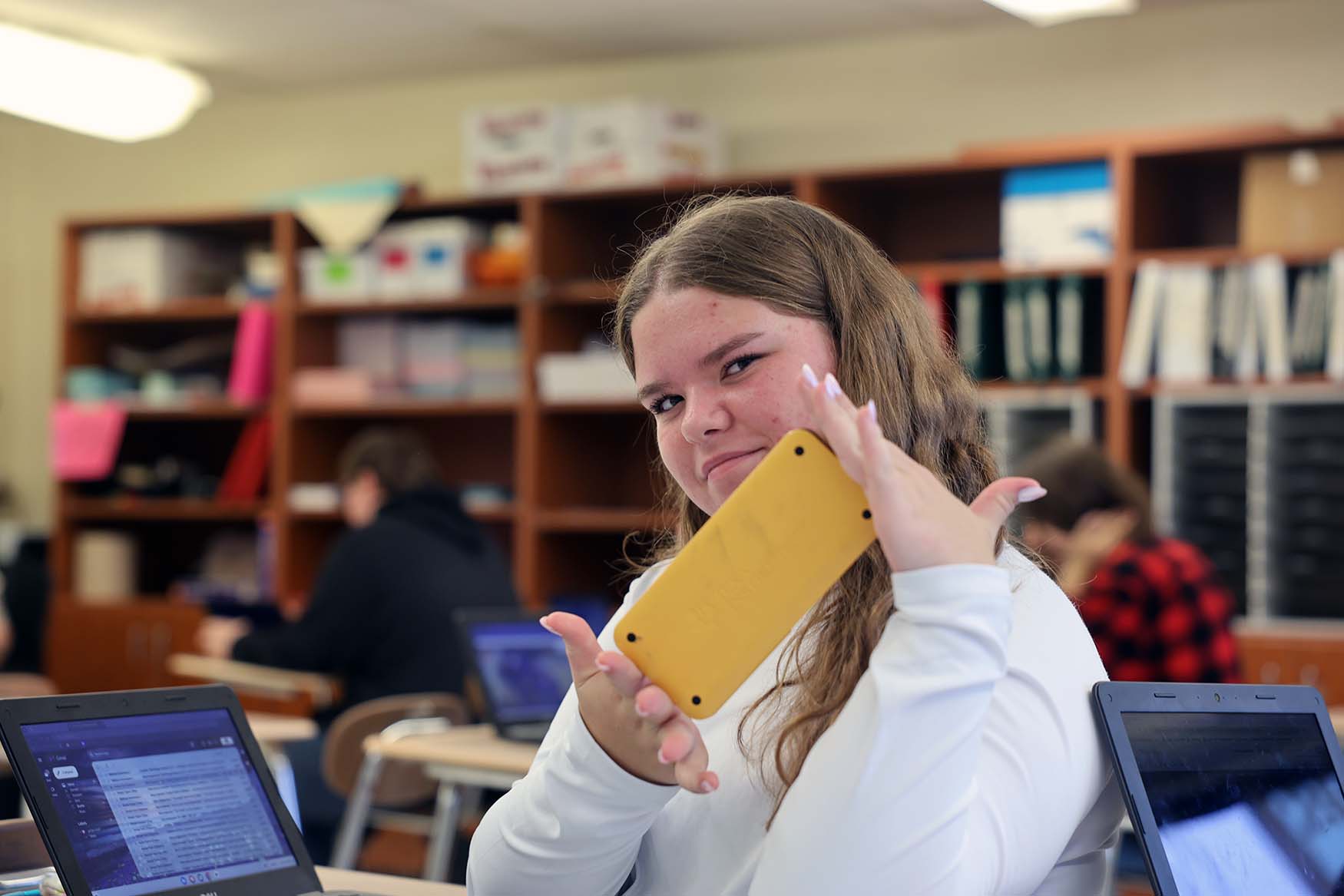hs student sitting at desk with yellow calculator