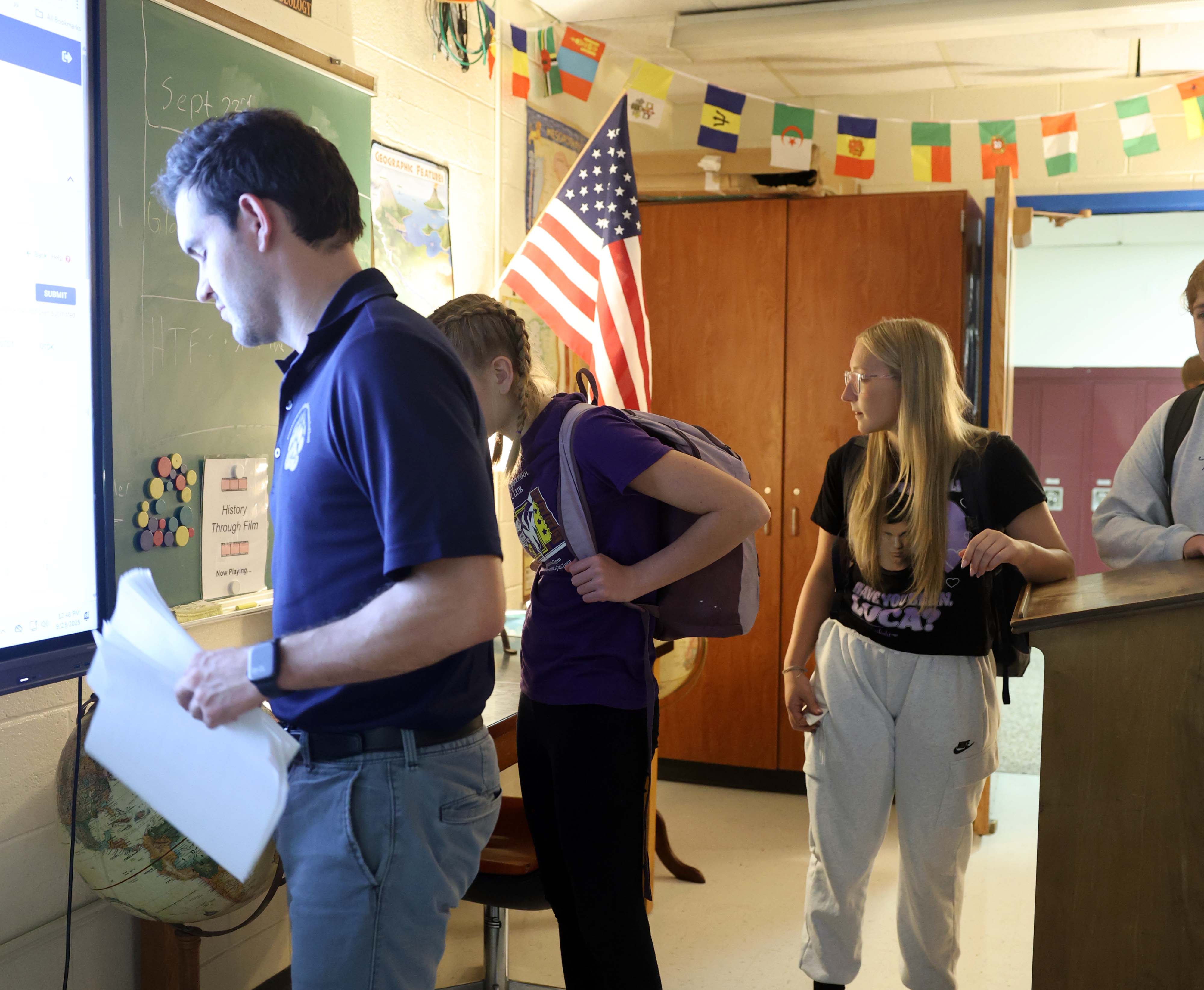 high school teacher at smartboard