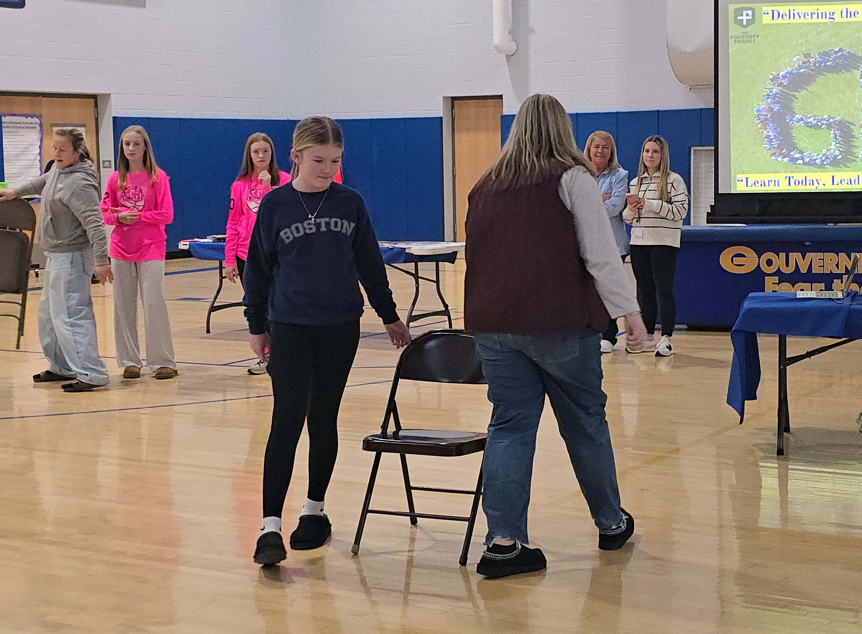 middle school teacher and student playing musical chairs